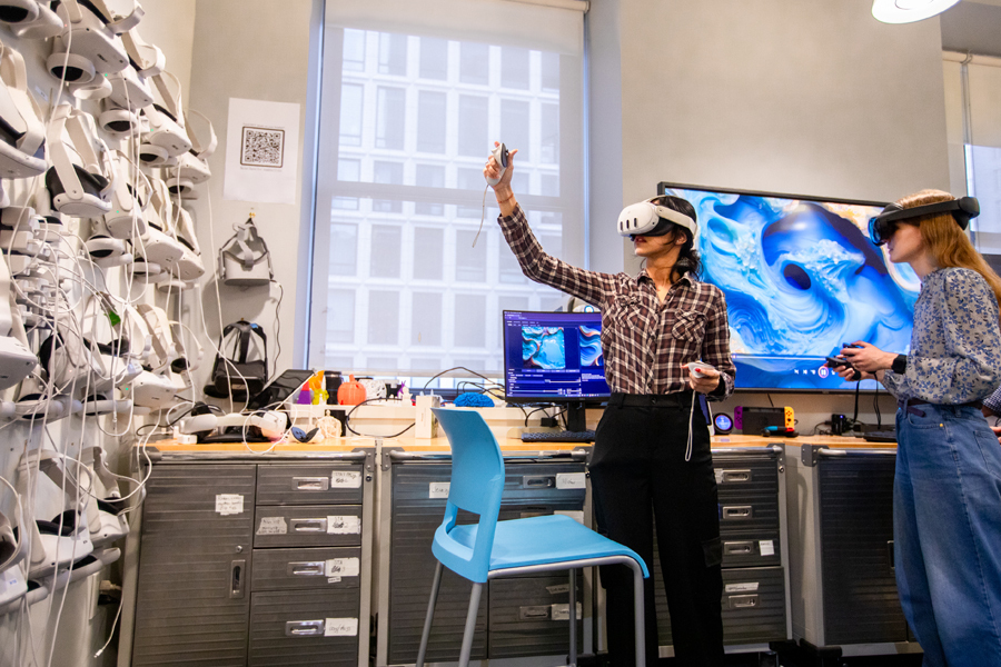 Two students use virtual reality goggles in New York Tech's Home for Innovation, Visualization, and Exploration.