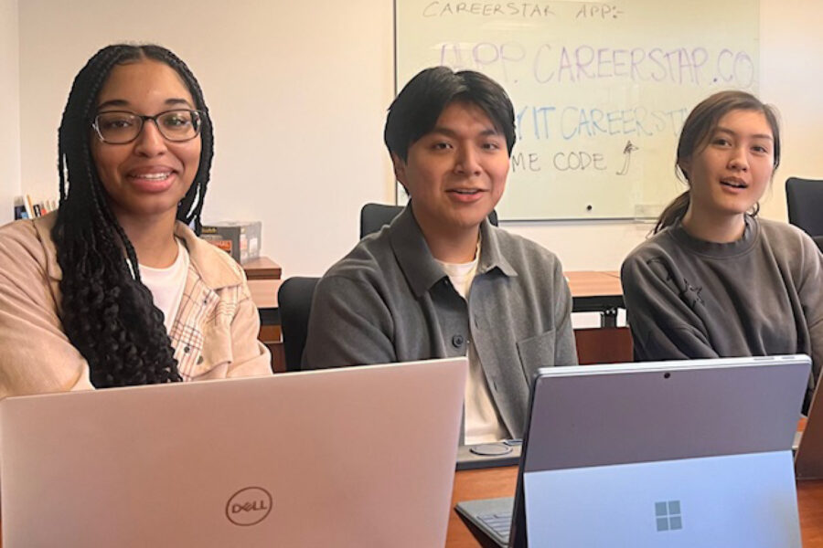 Three students sitting at a desk