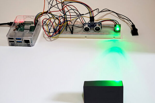 A photo of an electronics project using an ultrasonic sensor to create an interactive system.