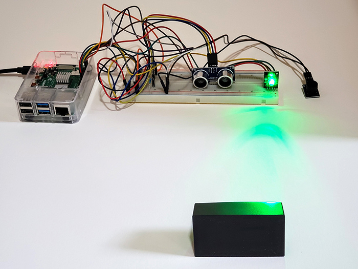 A photo of an electronics project using an ultrasonic sensor to create an interactive system.