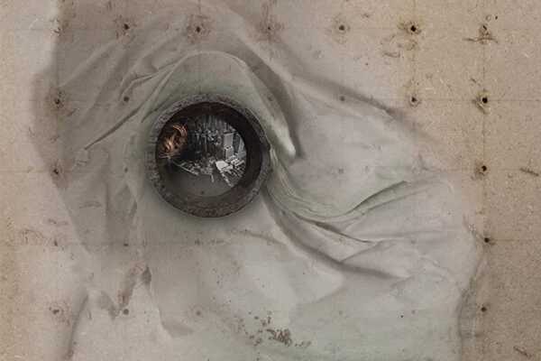 An abstract or artistic photograph that may depict a circular object, possibly a pipe or a lens, set into a textured surface with draped fabric.