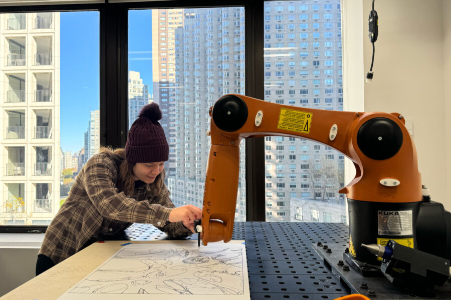 Student using a robotics arm