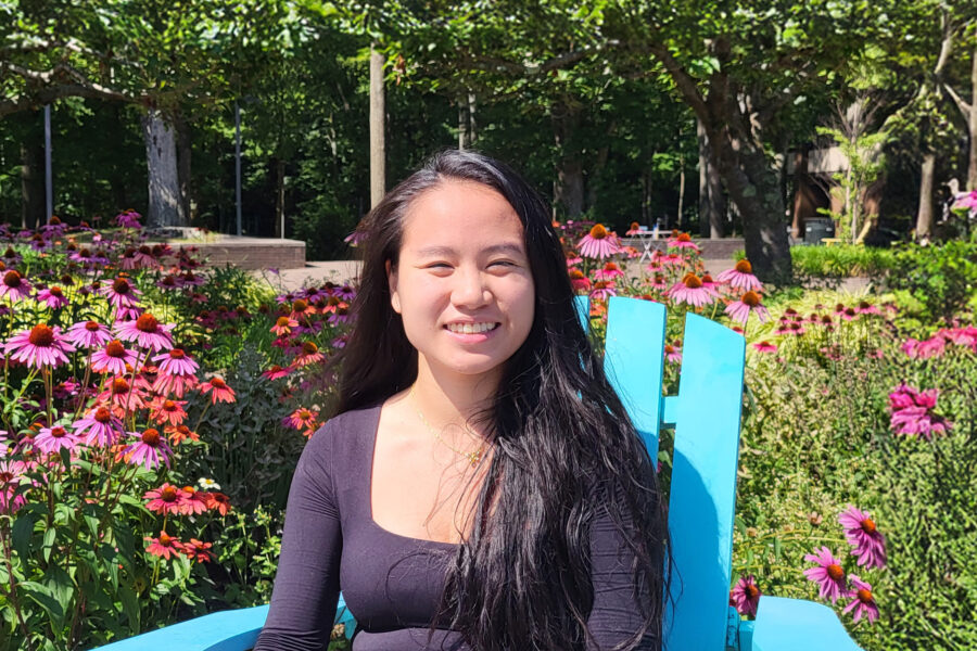 Skylynn Kilfoil Greaves sitting in a chair in a garden