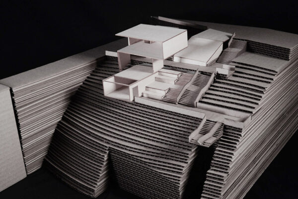 A photo of an architectural model of a modern structure built on a height
