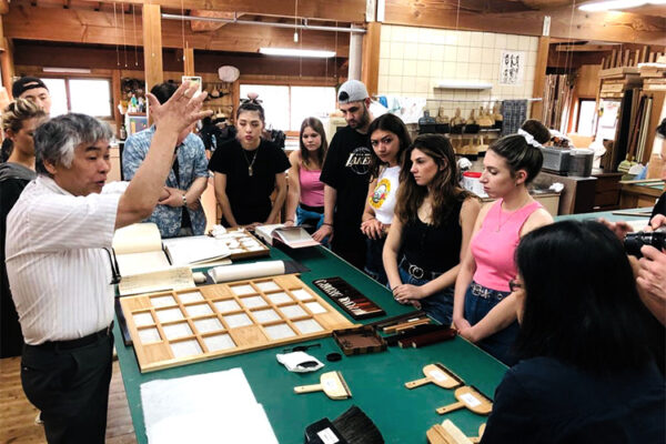 Study-abroad students at a traditional Japanese woodworking/paper-making workshop.