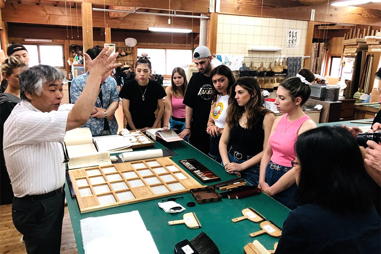 Study-abroad students at a traditional Japanese woodworking/paper-making workshop.