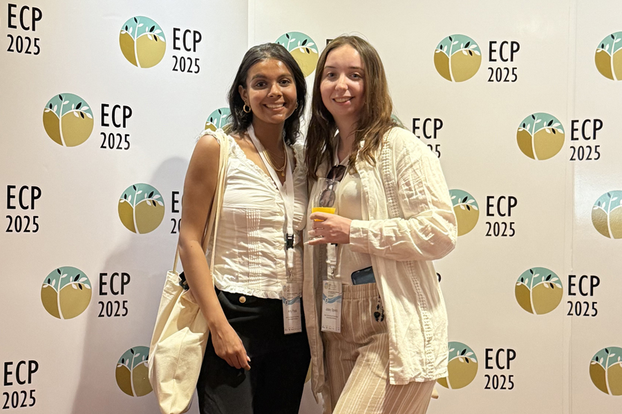 New York Tech alumni Josey Spiers and Amy Patel in front of step and repeat
