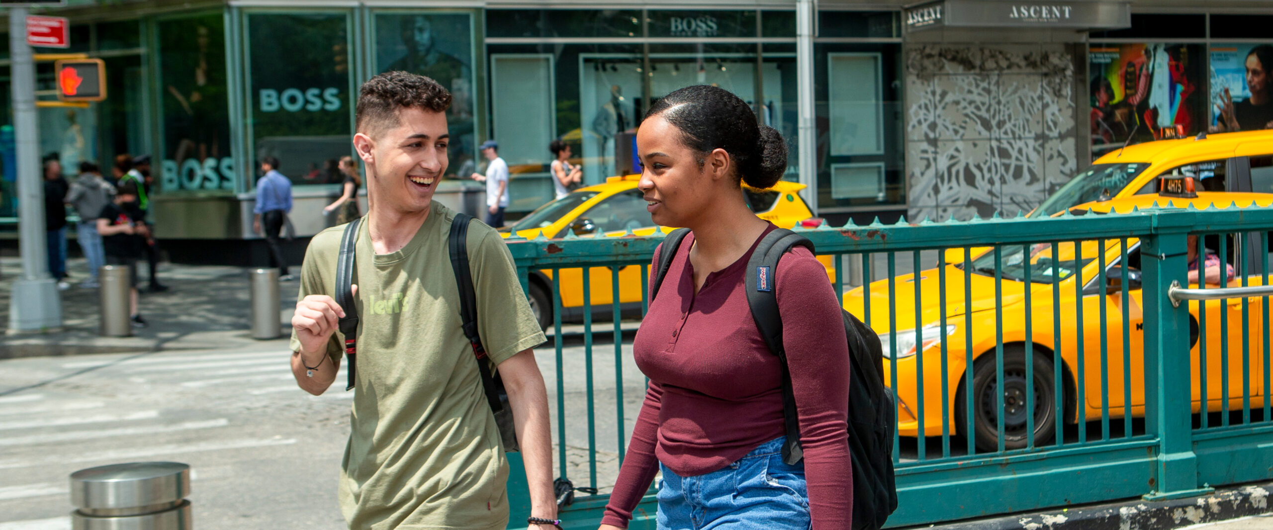 Two students walking near a New York City subway station