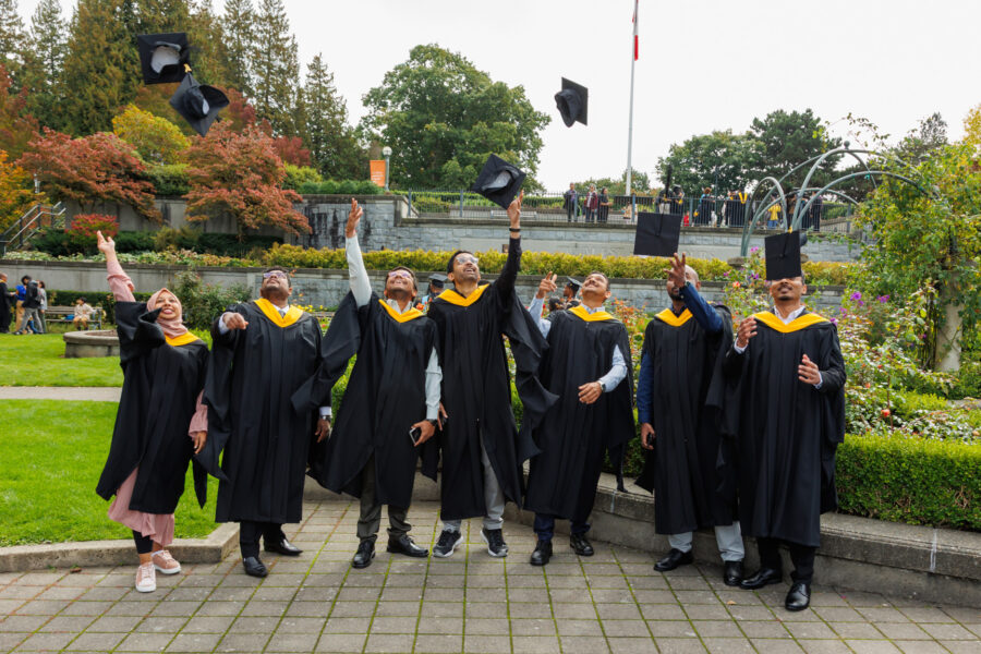 Graduates throwing caps in the air