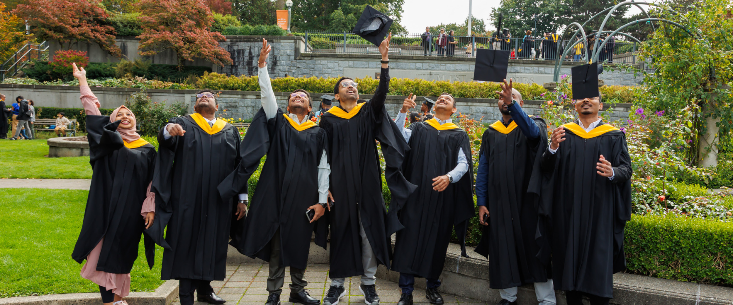 Graduates throwing caps in the air