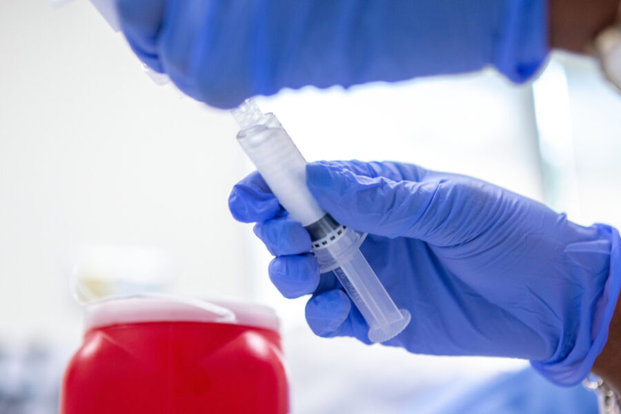 Hands holding vaccine syringe