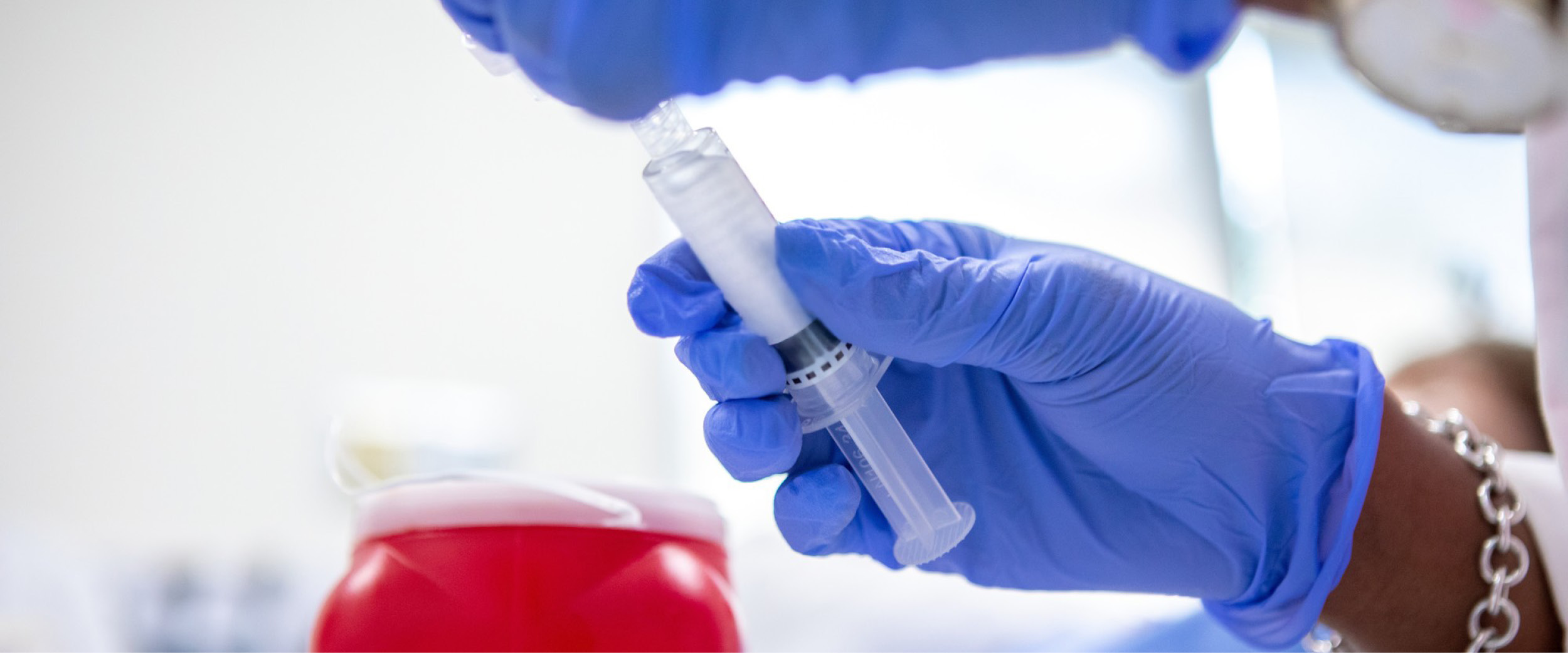 Hands holding vaccine syringe