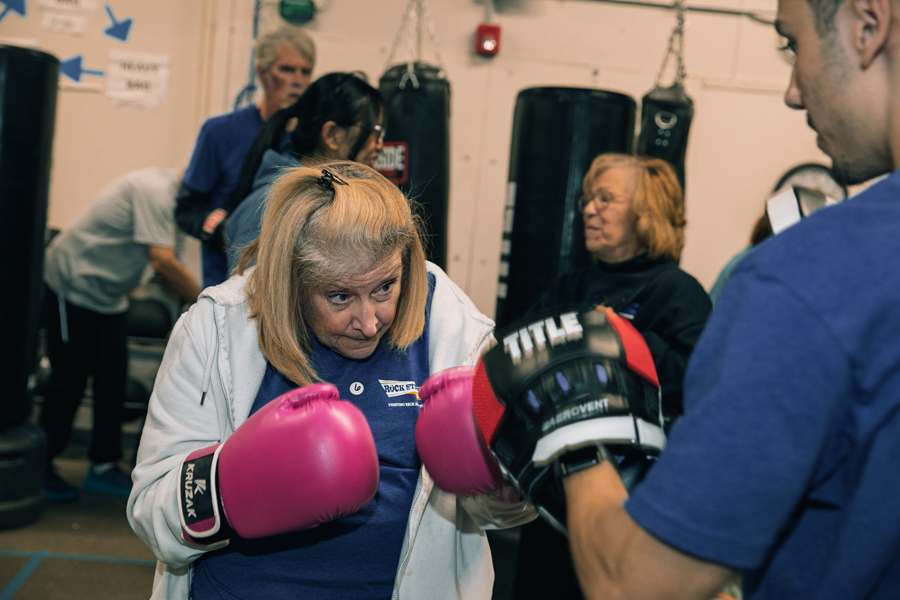Woman boxing wearing pink boxing gloves