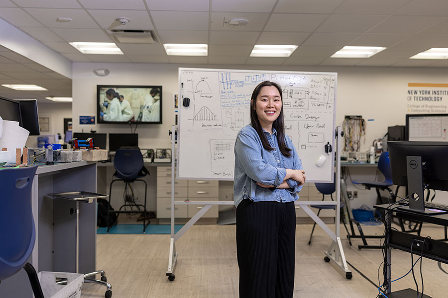 A student poses in the Entrepreneurship and Technology Innovation Center.