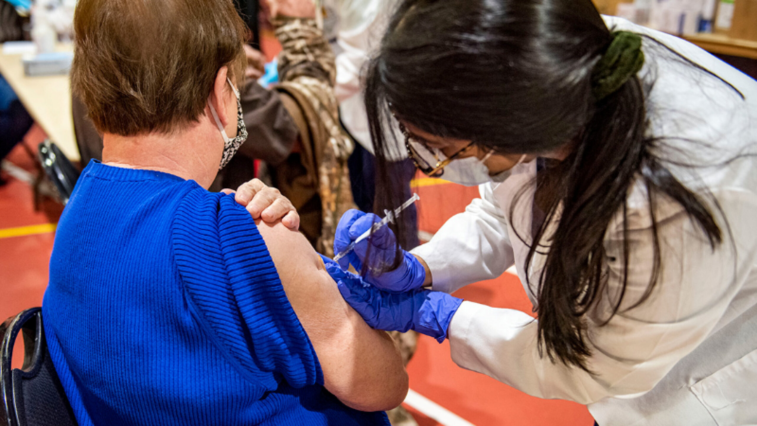 Physician administering a vaccine