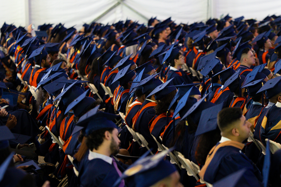 Students sitting wearing regalia