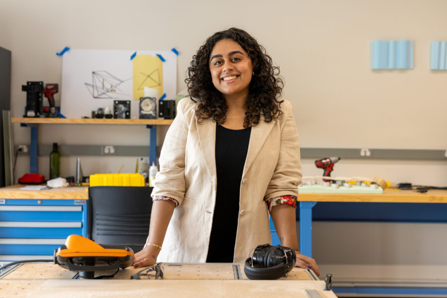 Daisy Madaan standing behind a desk