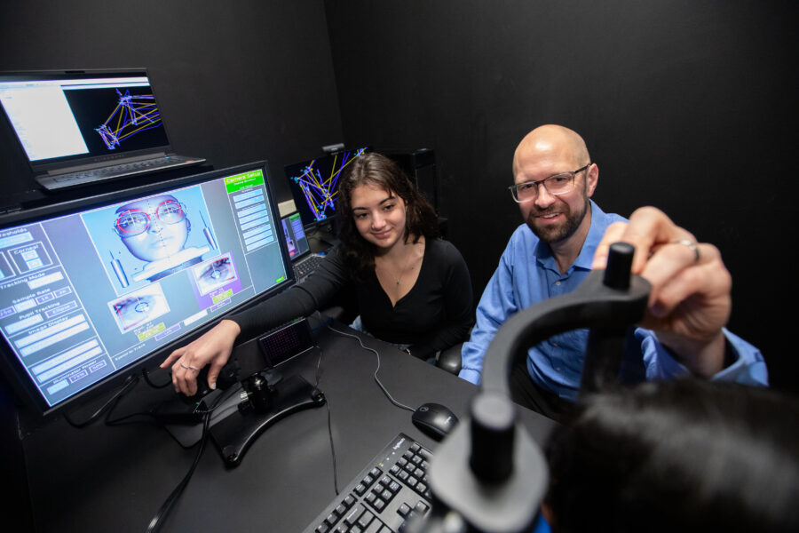 Talia Lilikakis and Robert Alexander working at a computer