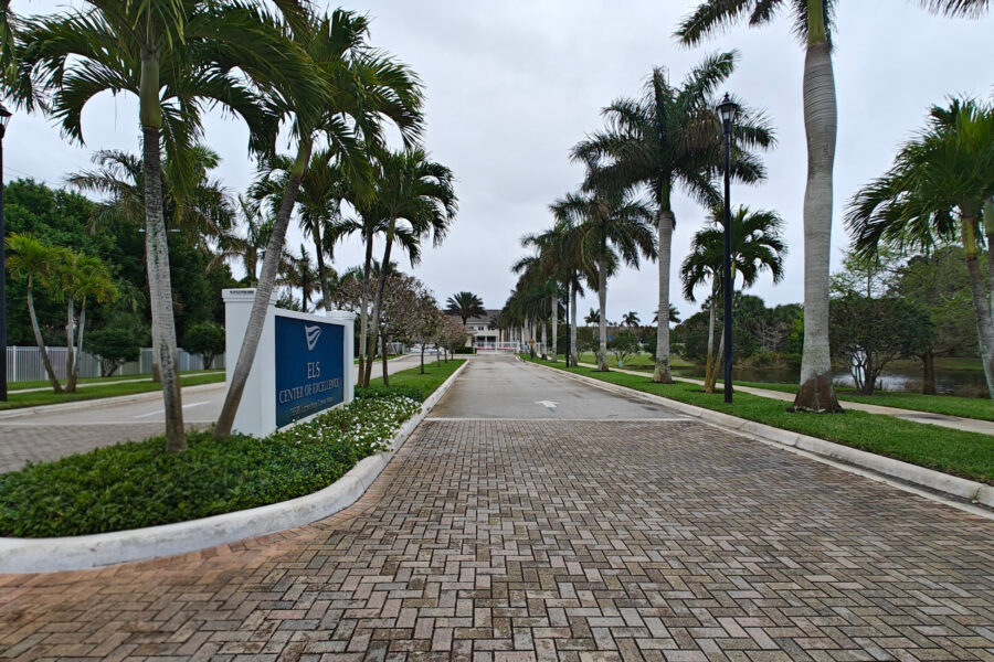 Image of landscaped driveway leading to building.