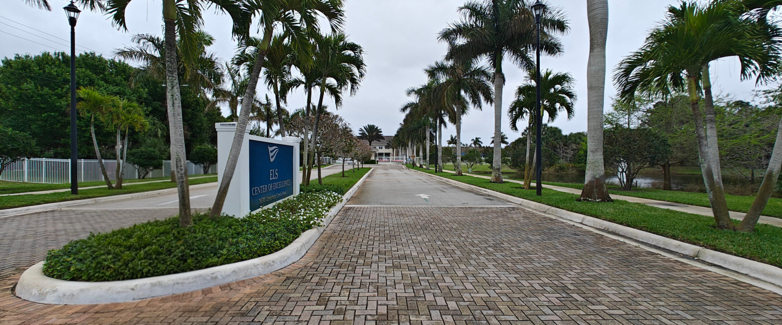 Image of landscaped driveway leading to building.