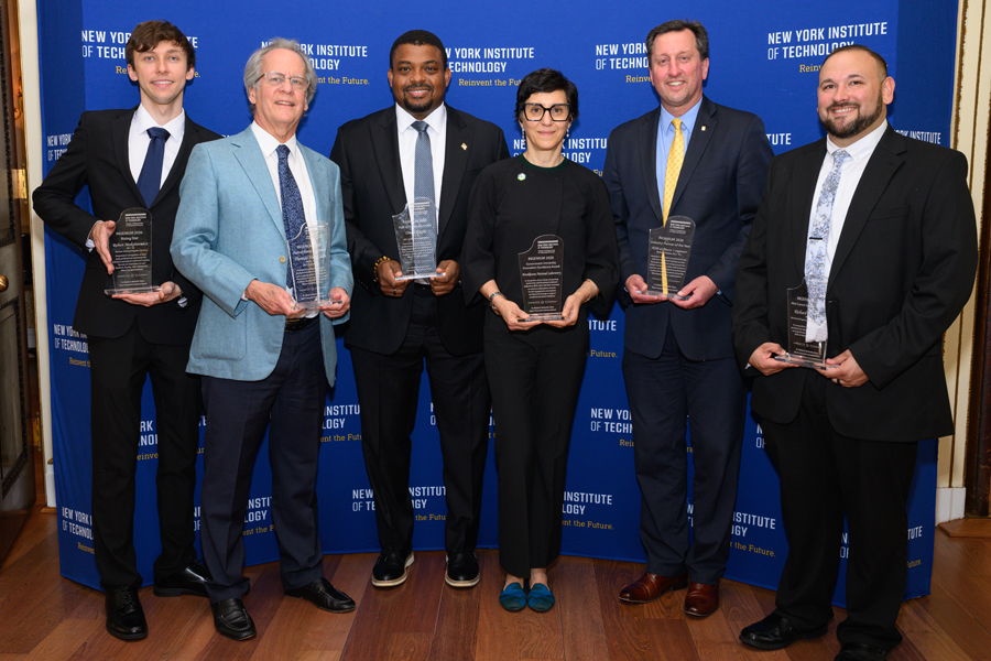 Award winners holding plaques