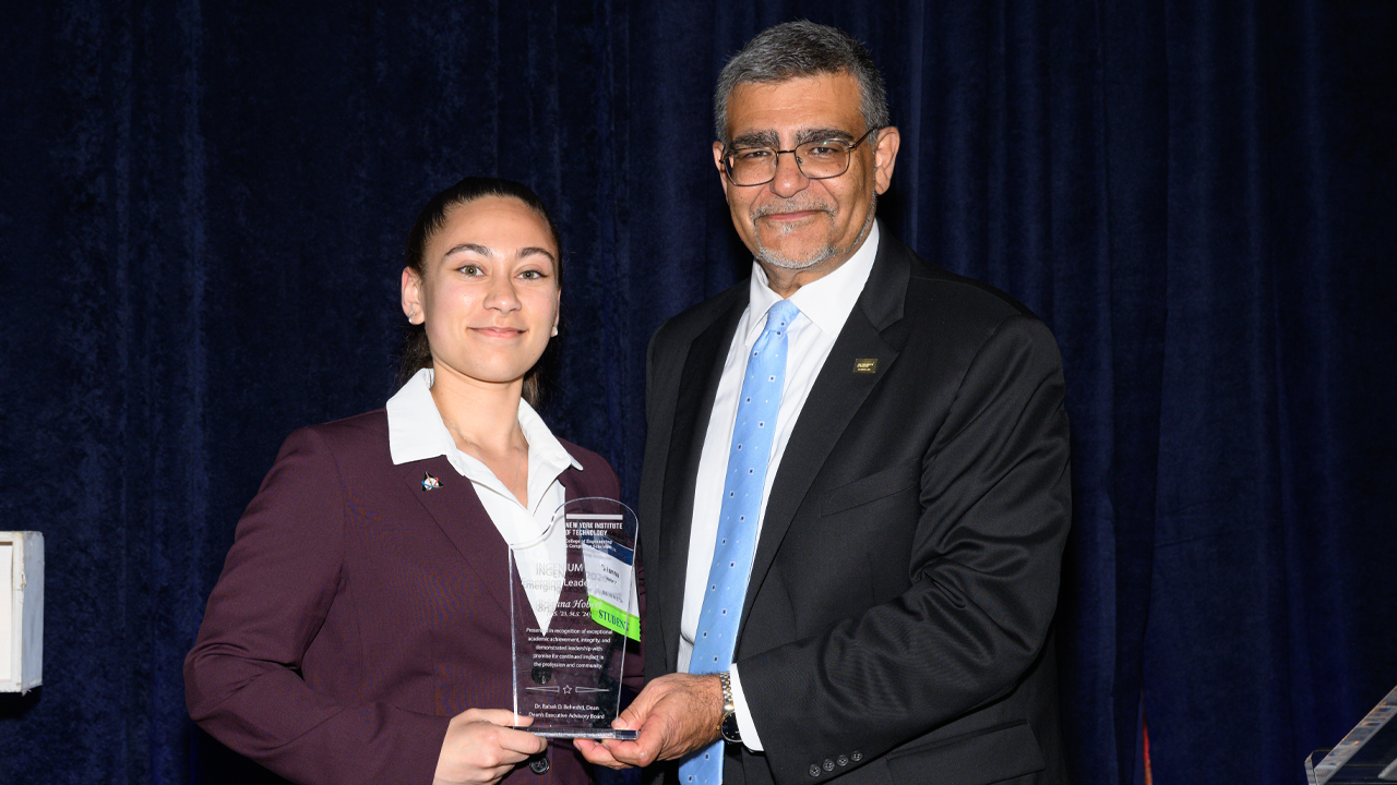Dean Babak Beheshti presenting Brianna Hobert with a plaque