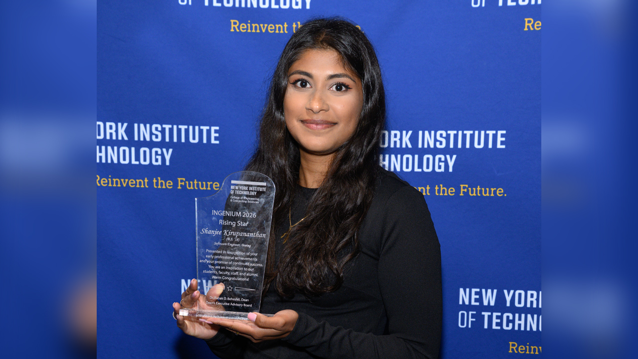 Shanjee Kirupananthan holding a plaque