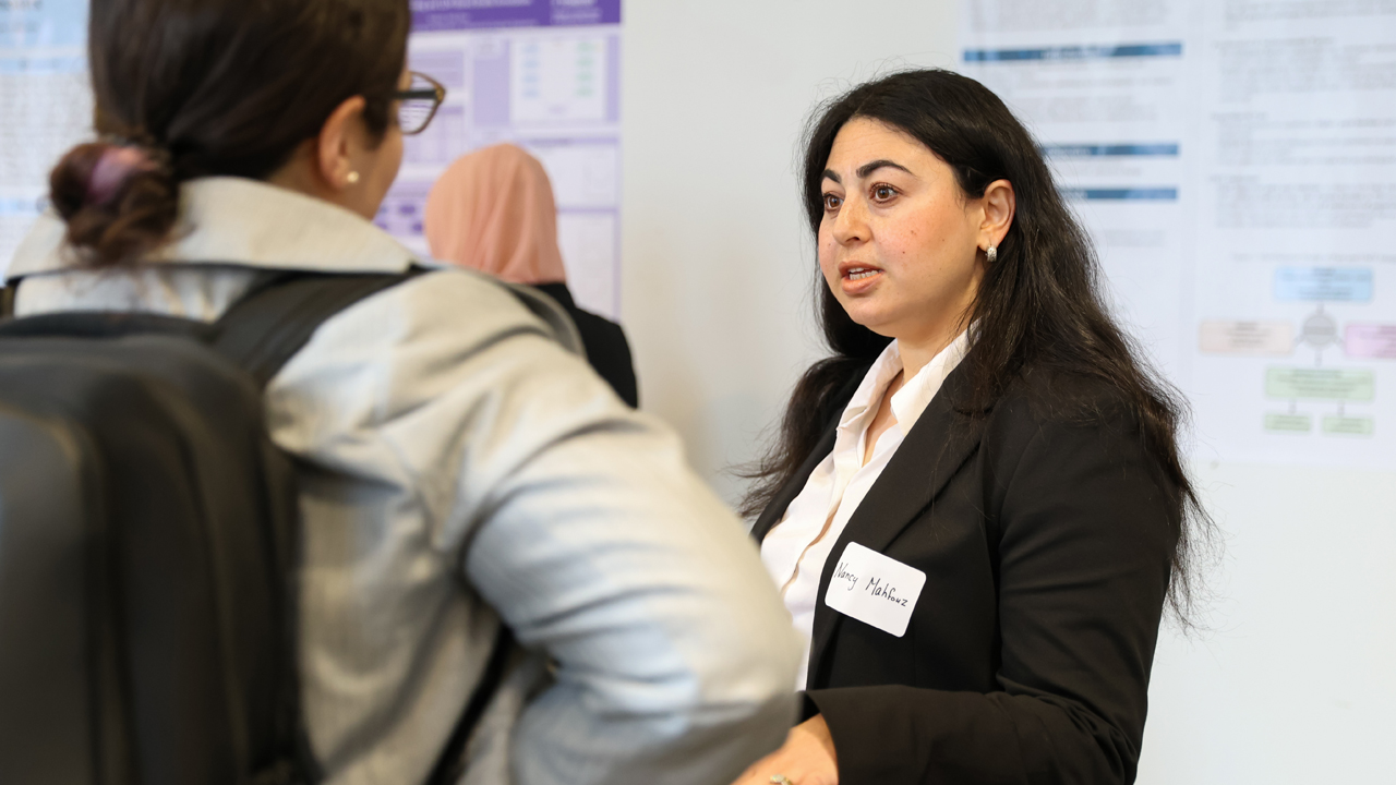 Student speaking to an attendee