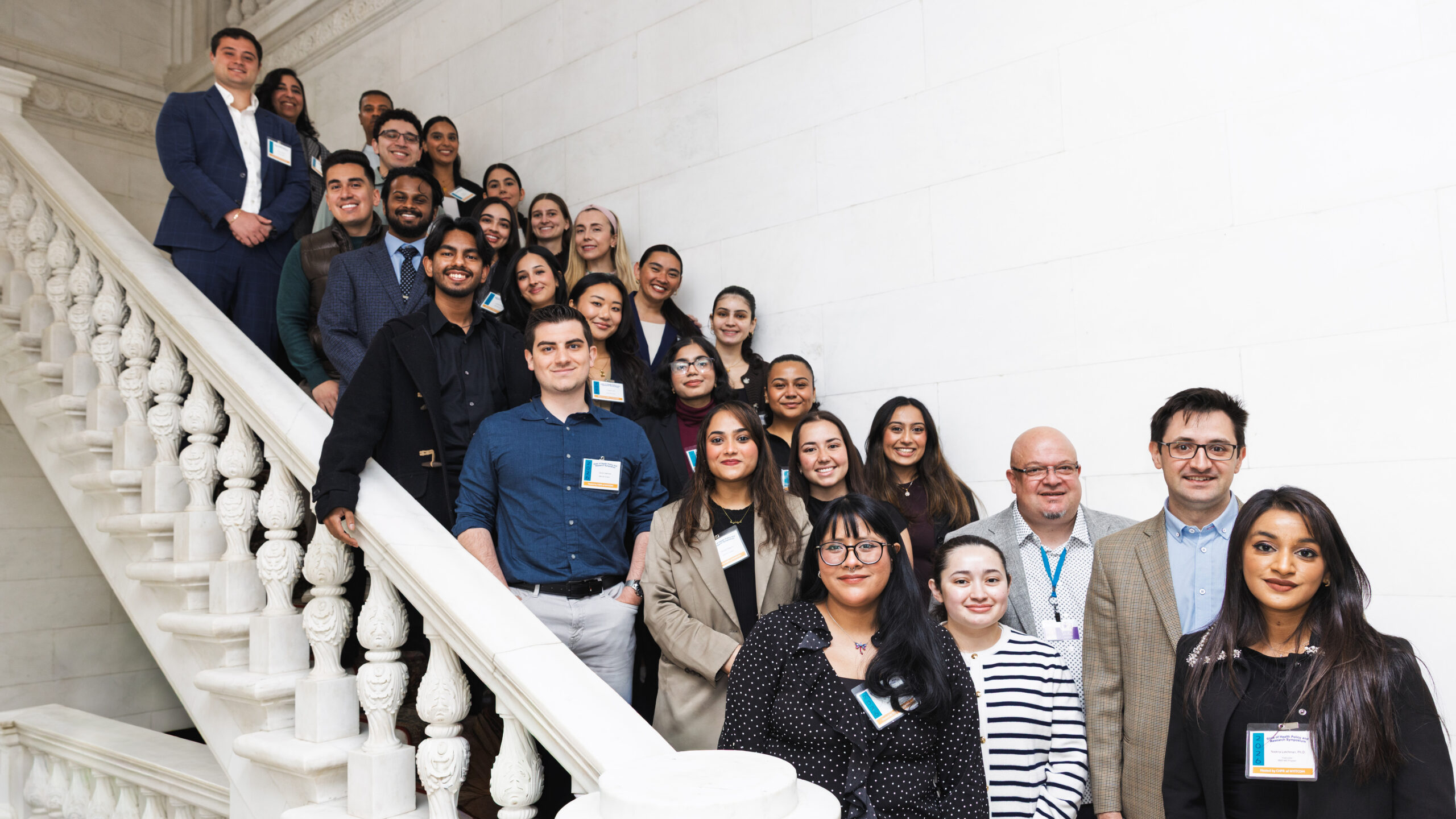 Professor Joerg Leheste standing with NYITCOM student researchers on stairs