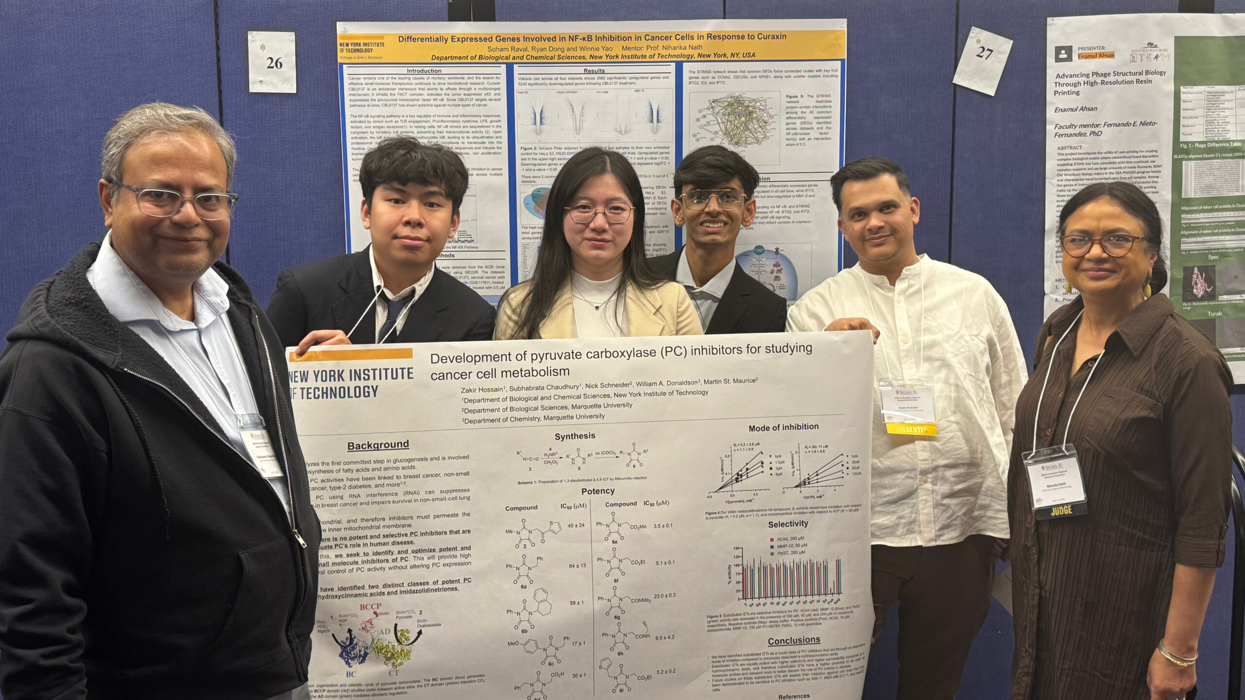 Students standing with their professors and research posters