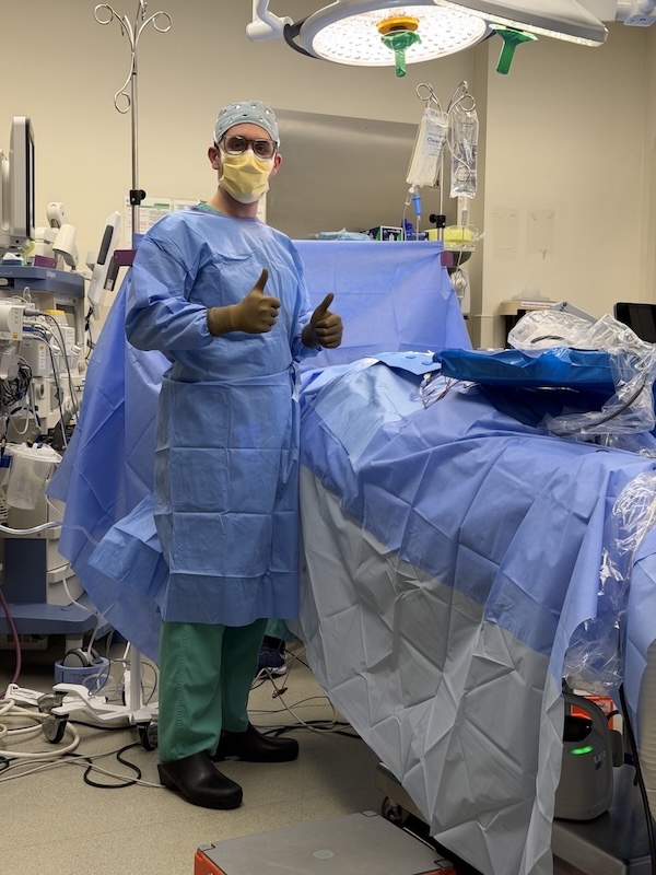 Ben Galinson in surgery scrubs in an operating room