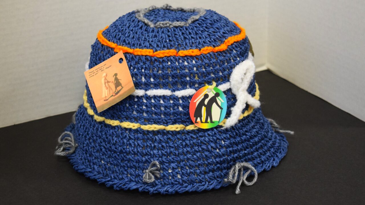 handmade woven/crocheted hat, yarn, fabric, paper tags
