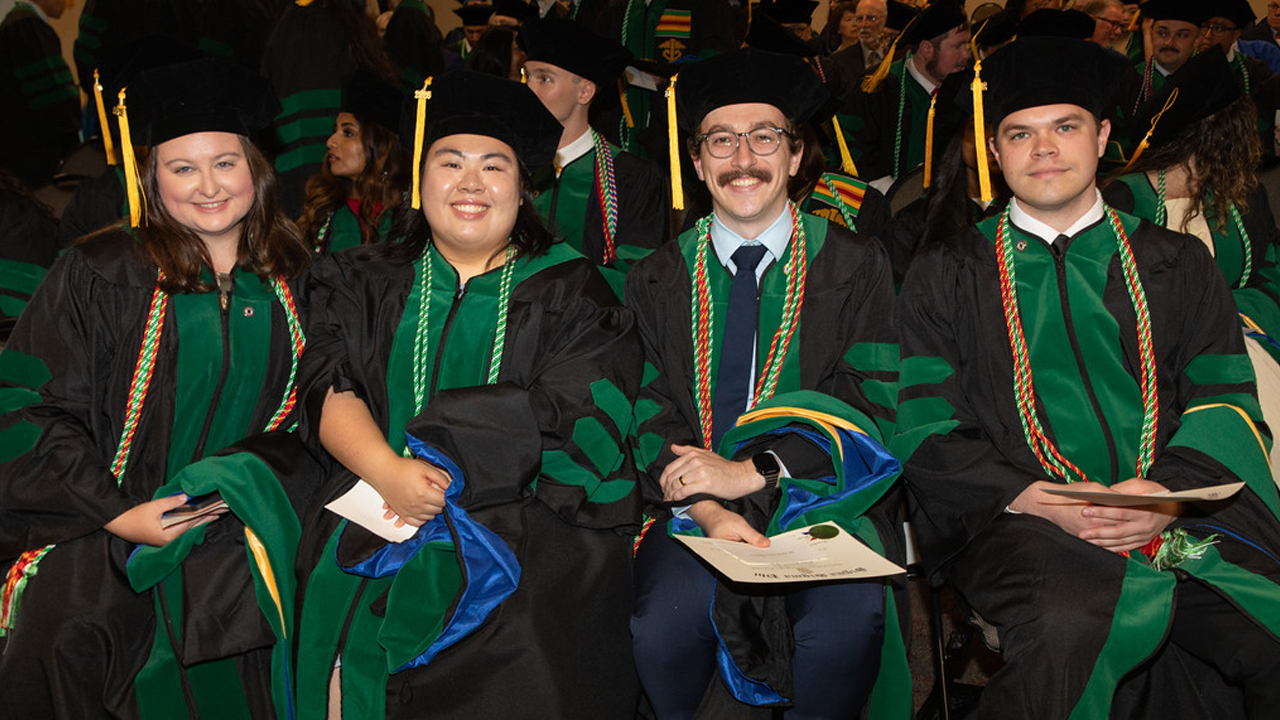 Students seated in caps and gowns