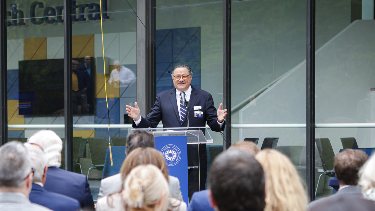 Peter Romano speaking at a podium