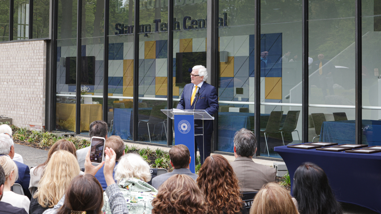 Hank Foley speaking at a podium