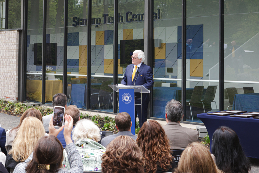 Hank Foley speaking at a podium