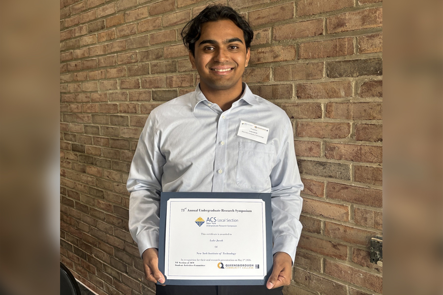 Luke Jacob holding a certificate