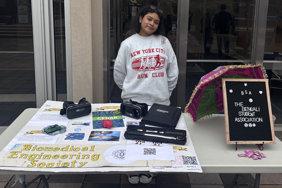 Aiesha Ayaana Hamid standing behind a table outside