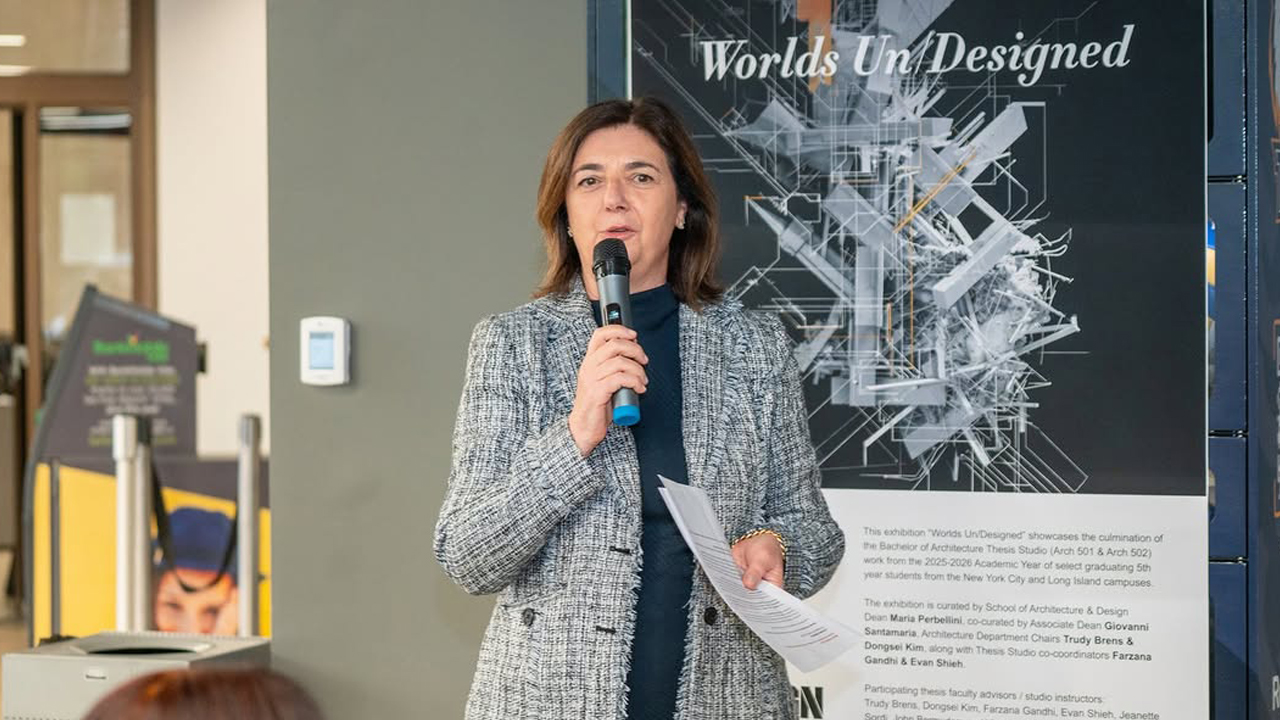 New York Tech Dean Maria Perbellini holding a microphone and speaking