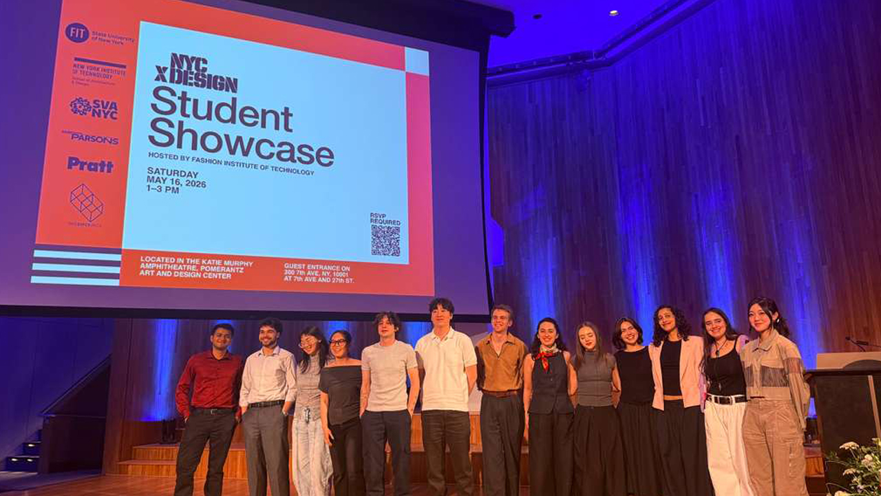 Group of students standing in front of a jumbo screen