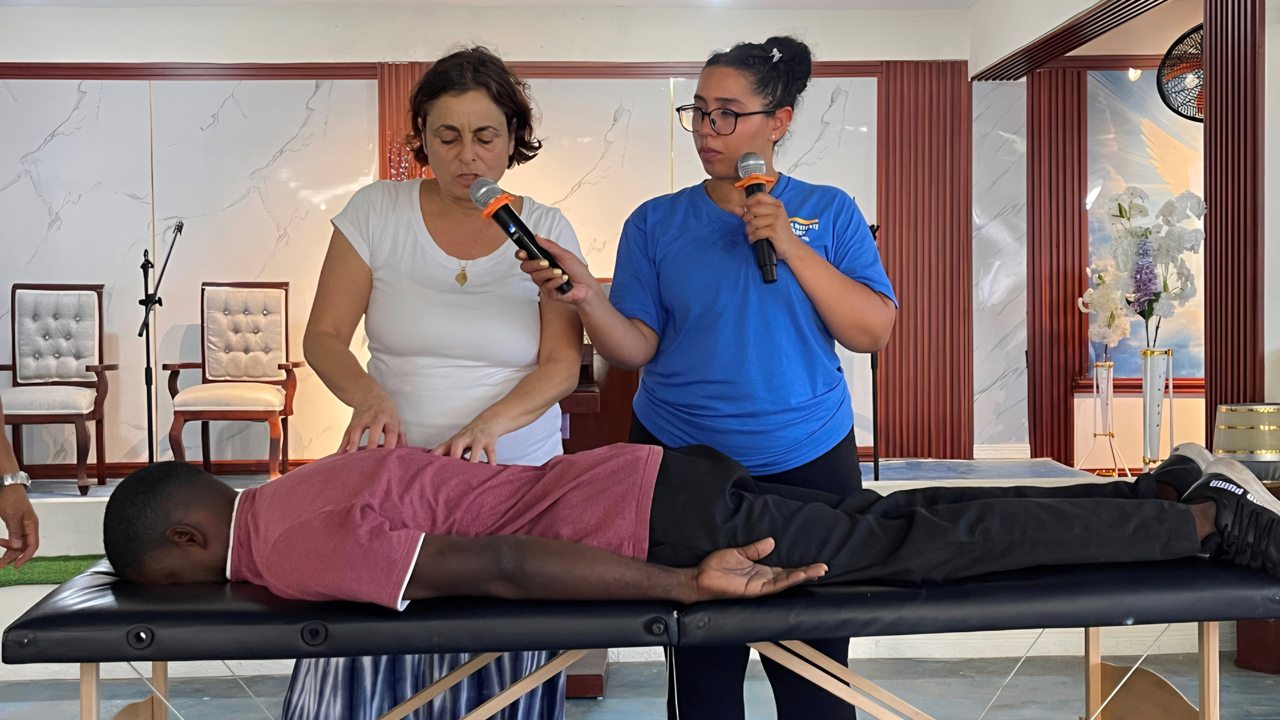 Professor and student demonstrating osteopathic techniques