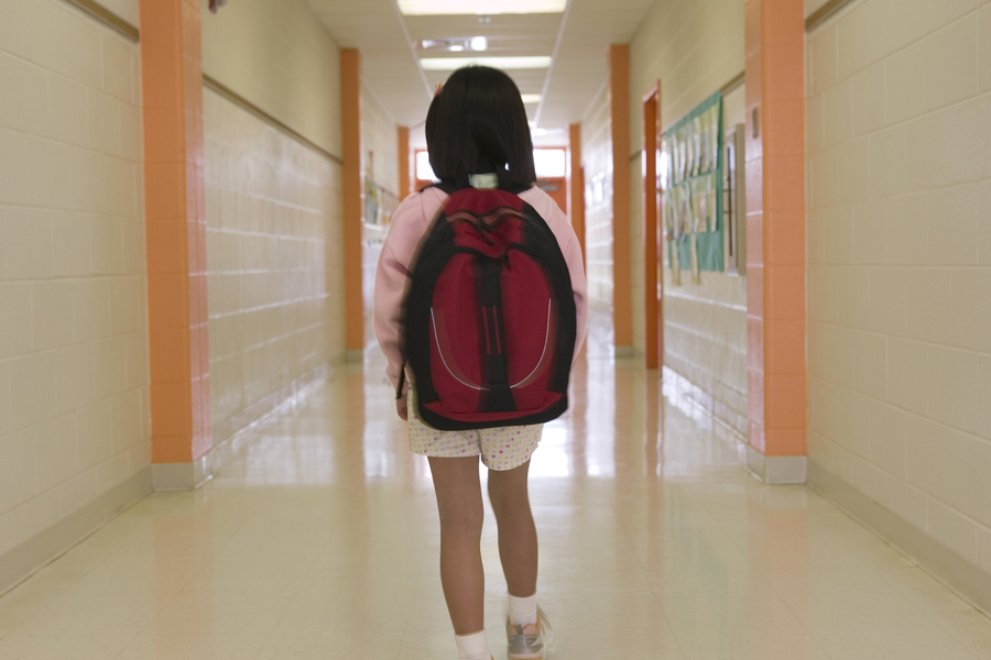 Young student walking down a hallway
