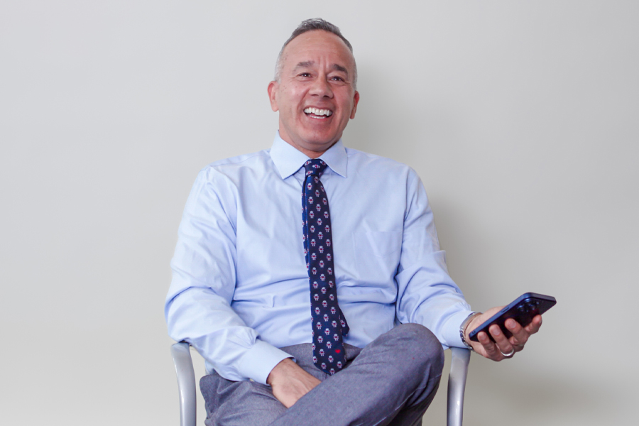 New York Tech professor Alex Lopez sitting in a chair