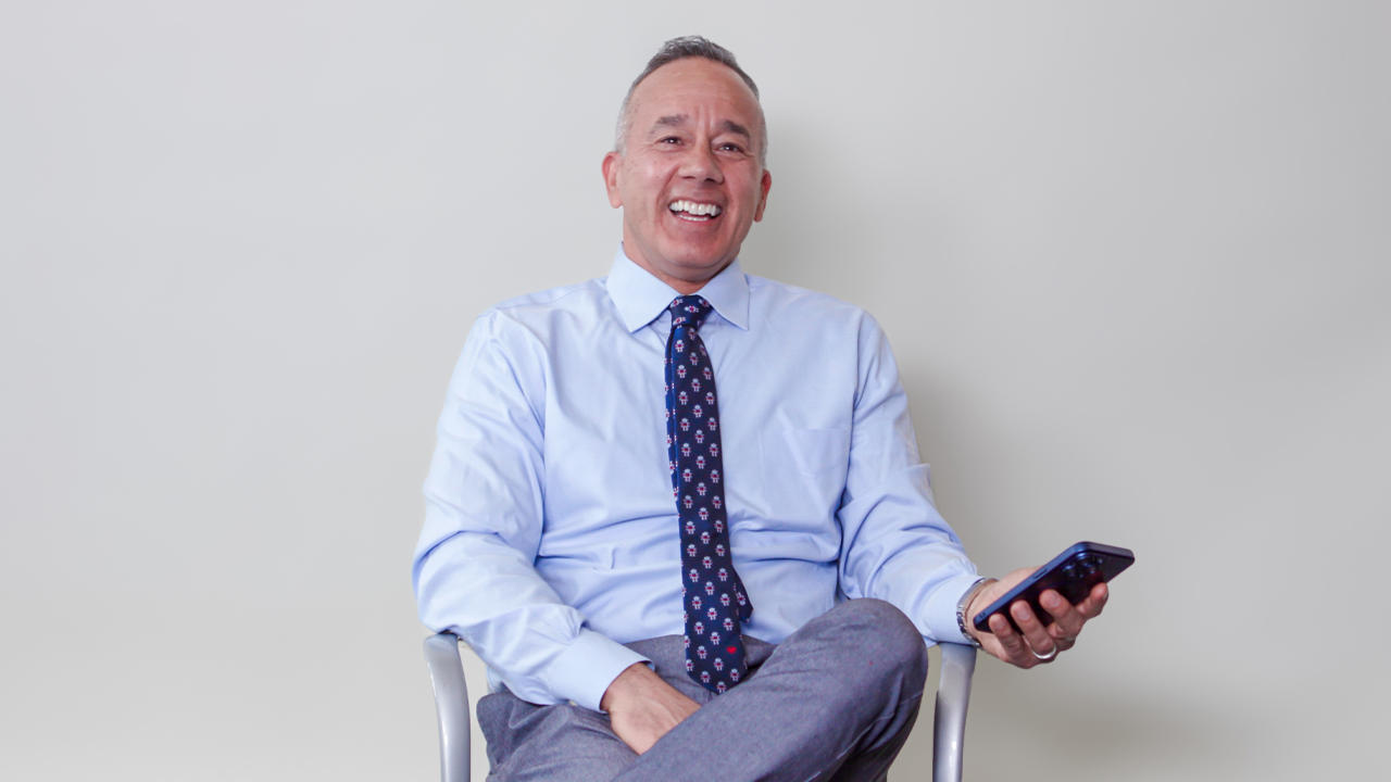 New York Tech professor Alex Lopez sitting in a chair