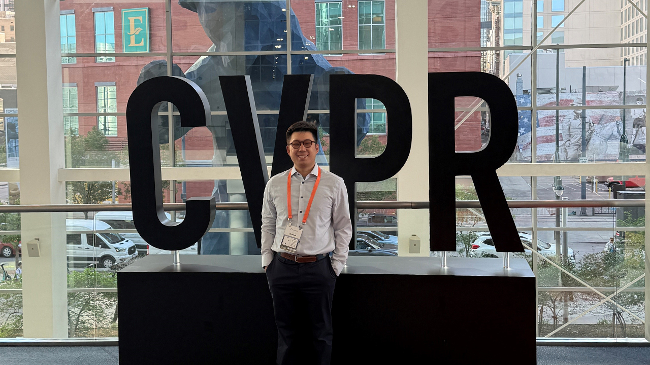 Student Bofan He in front of a window and the letters CVPR