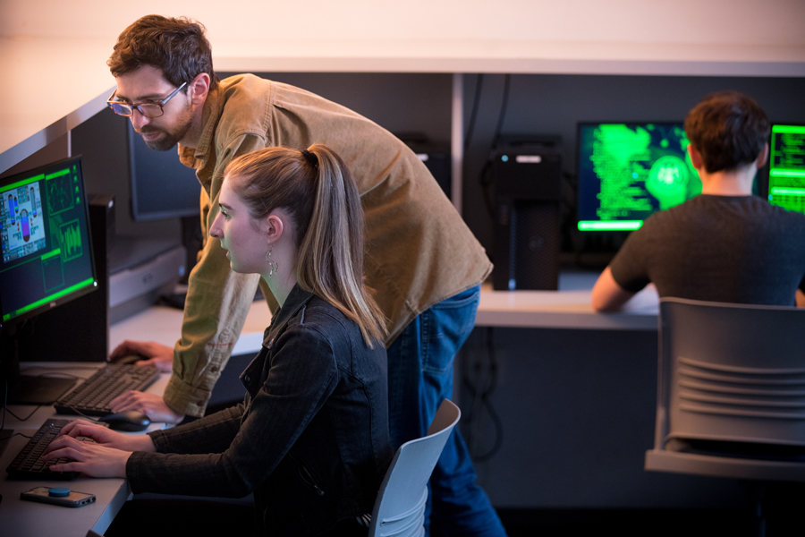 Two students are working in a computer lab.
