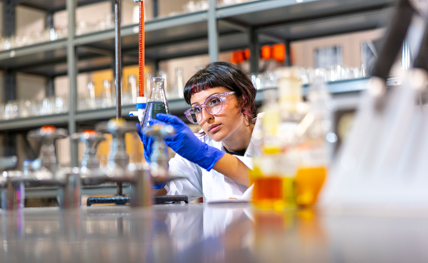 A student works with beakers in the chemistry lab.