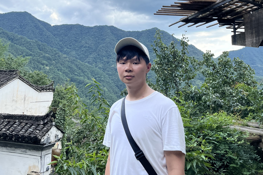 Irvin Chen standing in front of mountains