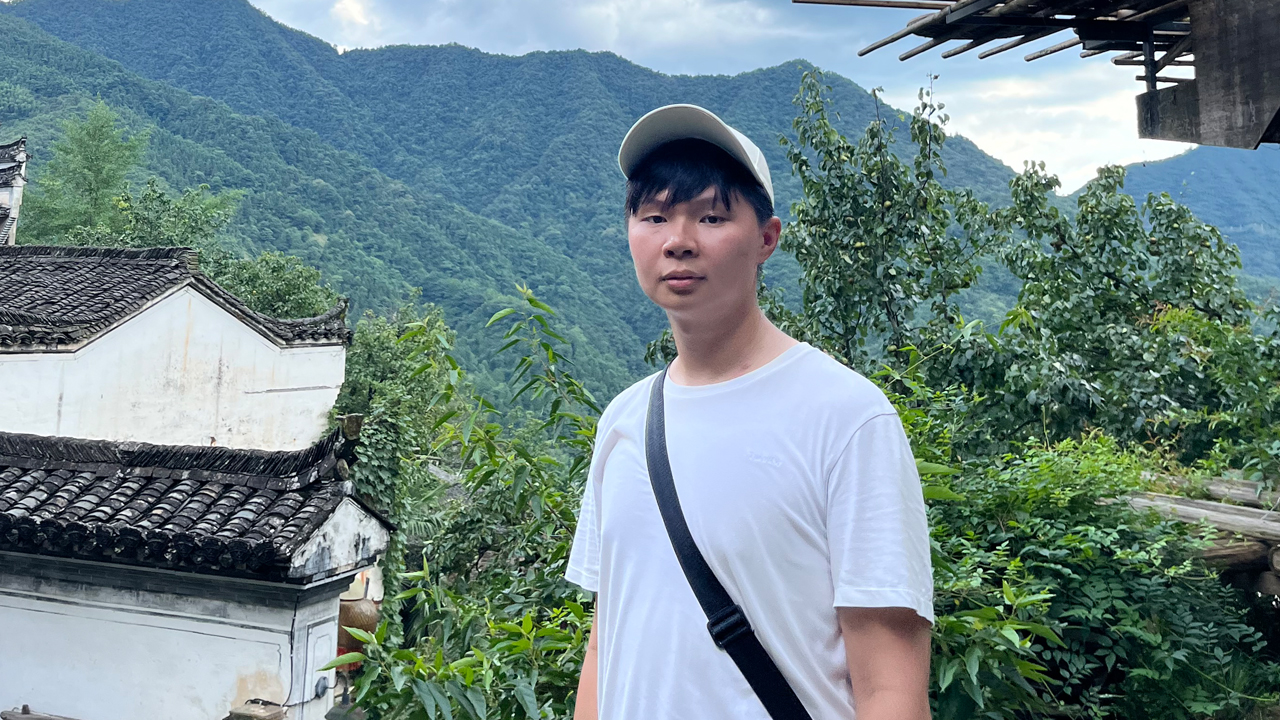 Irvin Chen standing in front of mountains