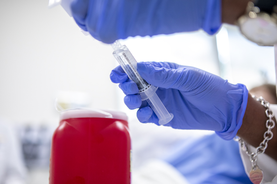 Hand holding vaccine syringe